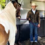 Photo of a man training a horse to enter a confined spae