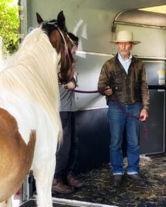 Photo of a man training a horse to enter a confined spae